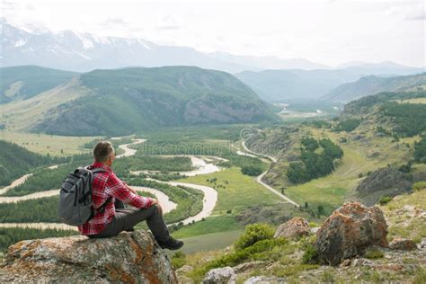 Man Hiker Sitting On Top Of Mountain Looking On Beautiful Panoramic
