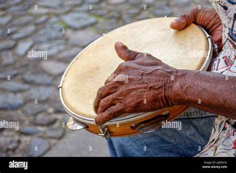 Hands And Instrument Of Percussionist Playing Tambourine In The Streets