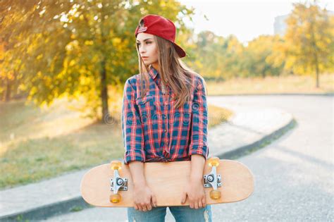 Beautiful And Fashion Young Woman Posing With A Skateboard Stock Image