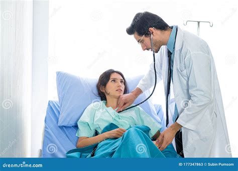 the doctor listened to the female patient heartbeat on the bed in the hospital room stock image