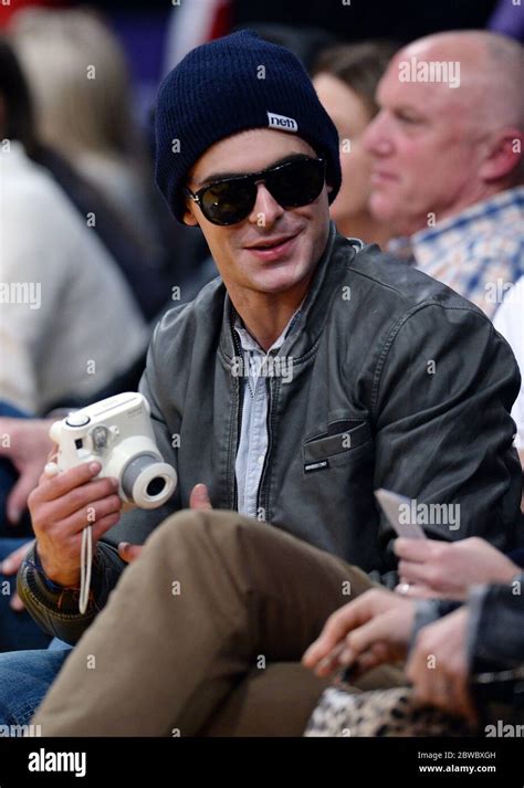 Zac Efron Wearing Beanie Holding Camera At La Lakers Nba Game