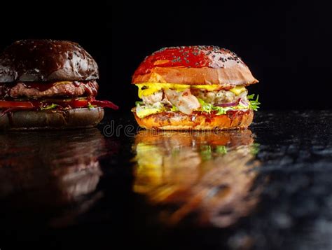 Set Of Two Delicious Burgers Isolated On A Dark Background The Concept