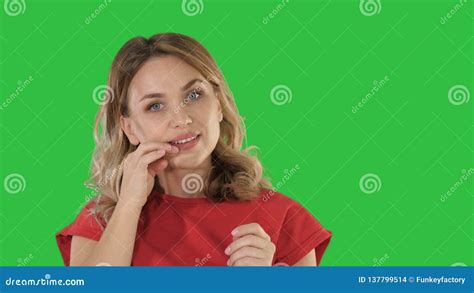 Beautiful Girl Preens Looking At Camera On A Green Screen Chroma Key