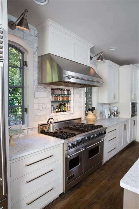 Fabulous kitchen features a stainless steel kitchen hood ...