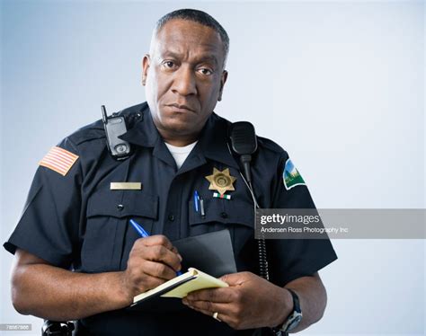 African American Male Police Officer Writing Ticket High Res Stock