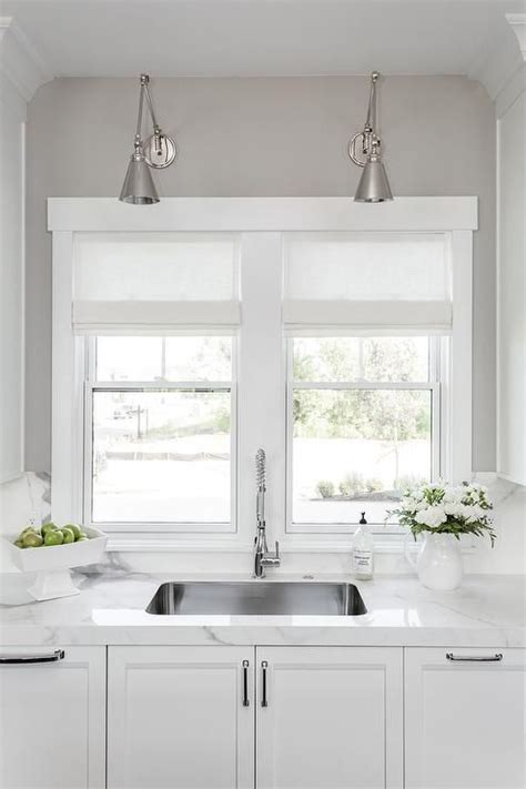 Consider woven baskets cleverly turned upside down and strung with a light kit. Polished Nickel Swing Arm Sconces Over Curved KItchen Sink ...