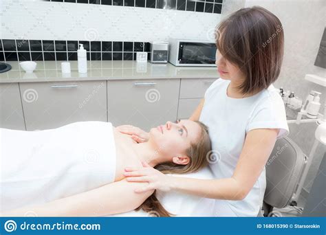 Young Woman On Facial Skin Rejuvenation Procedure Beautician Does Facial Massage With Hands