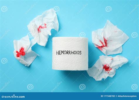 Toilet Paper With Hemorrhoids And Paper With Blood On Blue Background