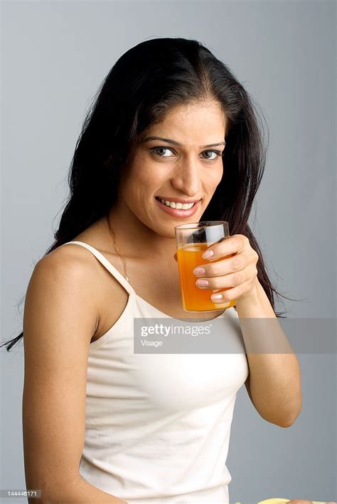 Portrait Of A Woman Drinking Juice High Res Stock Photo Getty Images