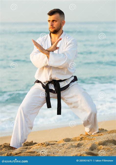 Young Man Is Exercising To Doing The Shiko Dachi Stance Stock Image