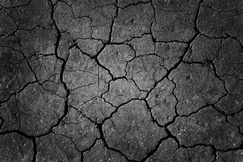 Black Cracked Surface Of Grey Soil Texture Background Dark Dried And