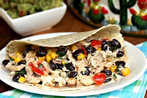 Shred the chicken with 2 forks. Crock Pot Chicken Tacos - The Cozy Cook