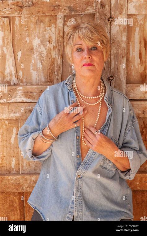 Attractive Mature Woman Posing In Her Derelict Spanish Barn Stock Photo