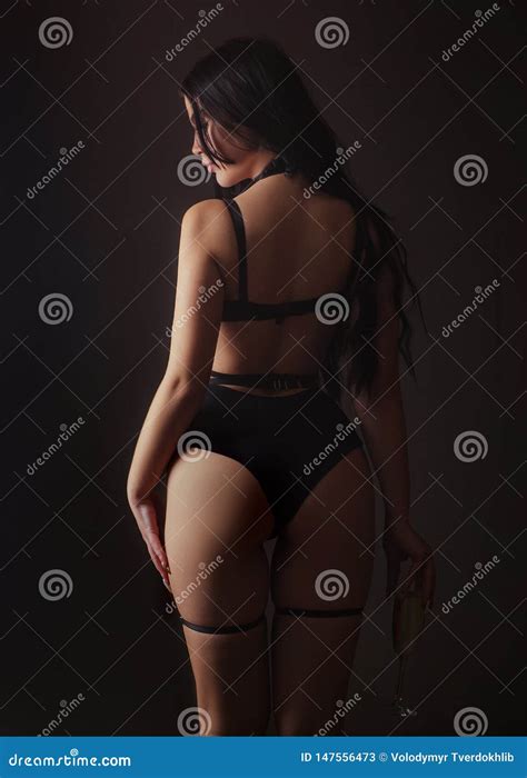 Slim Woman Dressed In Black Lingerie And Tied With Ropes Female In