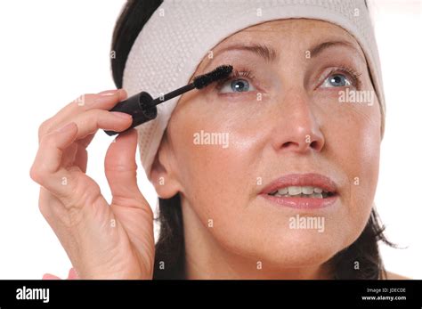 Closeup Portrait Of Mature Woman Applying Mascara On Eyelashes 50 Year