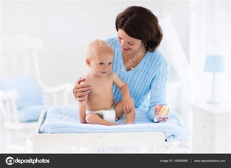 Mother Changing Diaper To Baby Boy Stock Photo By ©famveldman 142690995