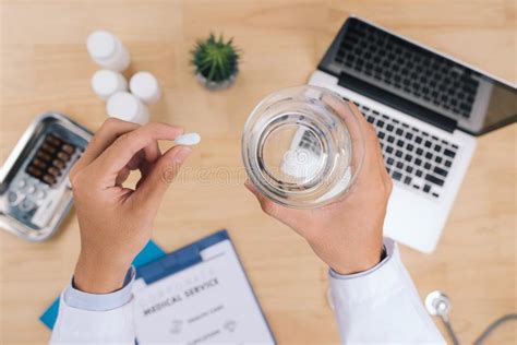 Doctor Holding A Glass Of Water And Pill Medicine Close Up Heal Stock