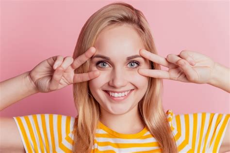 Premium Photo Portrait Of Charming Funny Lovely Lady Fingers Show V Signs On Pink Background