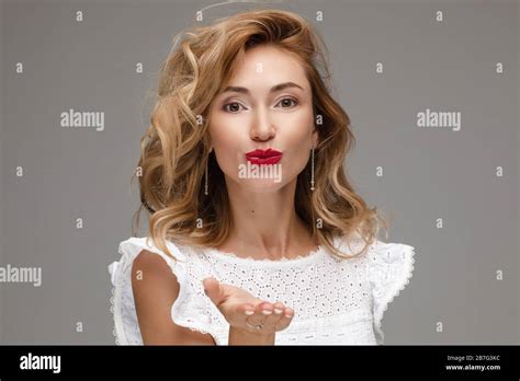 Beautiful Blonde Woman With Red Lips Sending Air Kiss Stock Photo Alamy