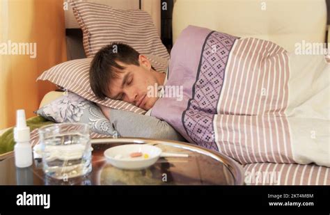 Sick Man Lying On Bed And Coughing Stock Video Footage Alamy