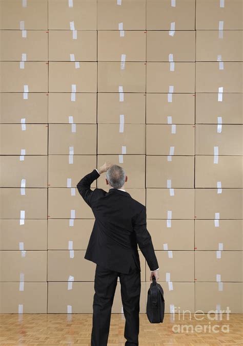 Businessman Facing A Cardboard Boxes Wall Photograph By Sami Sarkis