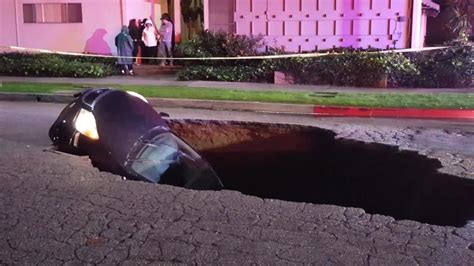 Sinkhole Swallows Two Cars With Driver Still Inside
