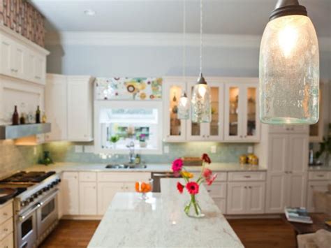 Light kitchen cabinets with dark countertops. Farmhouse Kitchen with Mason Jar Pendants Over Island | HGTV