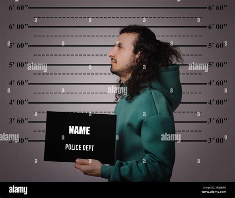 Criminal mugshot. Arrested man with blank card against height chart