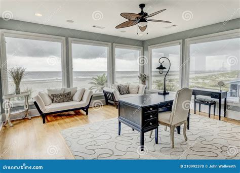 Luxury Home Office With Large Windows And A View Of The Ocean Stock