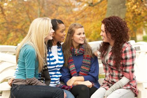 Group Of Four Teenage Girls Sitting And Chatting Stock Photo Image Of