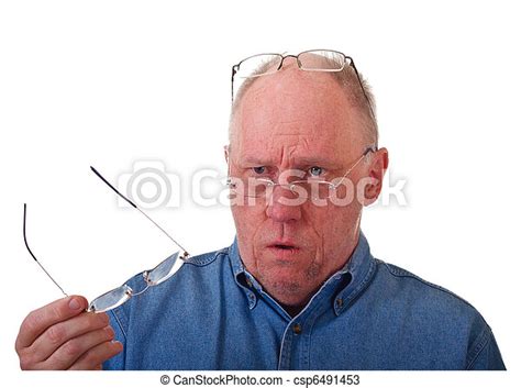 Older Balding Man Confused Over Reading Glasses An Older Balding Man In Blue Denim Shirt With