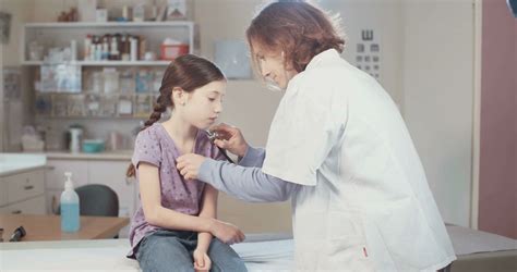 Female Doctor Checking A Sick Girl Using A Stethoscope Stock Video