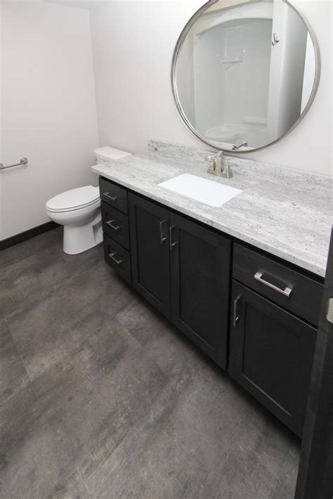 Not only is it waterproof (making it ideal for kitchens and bathrooms), many of the click and lock varieties can be installed. Dark Gray Luxury Vinyl Tile Bathroom Floor (With images ...