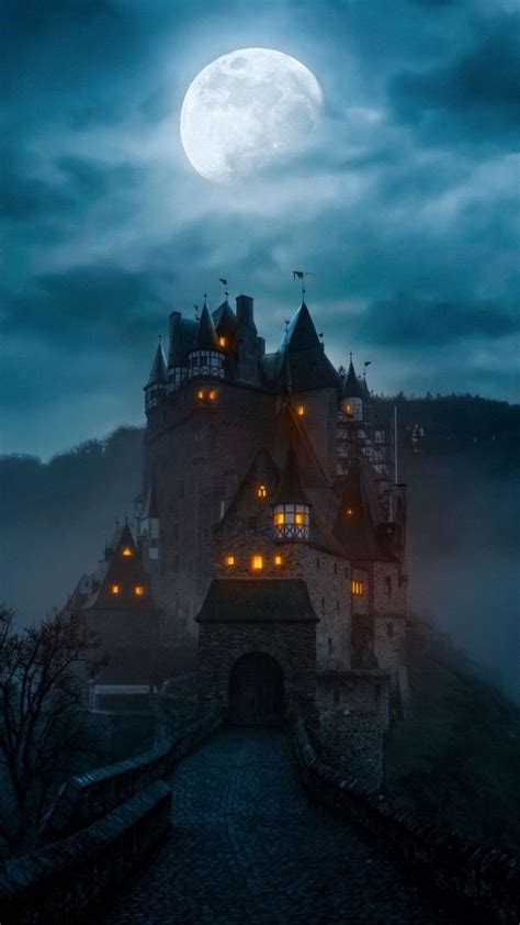 An Old Castle In The Middle Of A Foggy Night With Full Moon Behind It