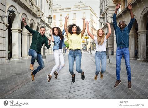 Multi Ethnic Group Of Young People Having Fun Together Outdoors In