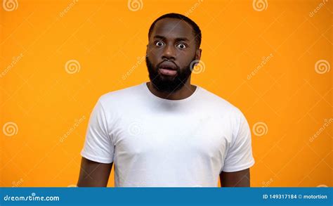 Shocked African American Man Looking At Camera Isolated On Yellow