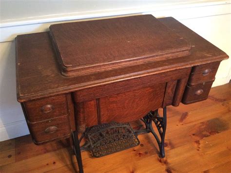 Sewing machine with case and folding table. antique treadle sewing machine New Home brand. Oak cabinet ...