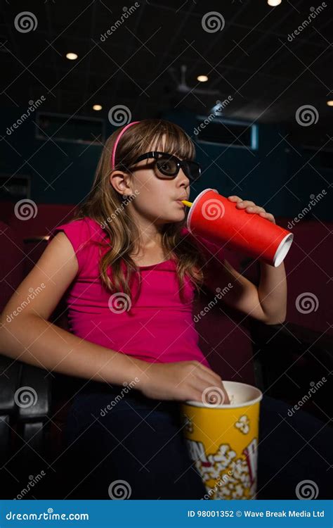 Girl Wearing 3D Glasses While Having Drink And Popcorns During Movie