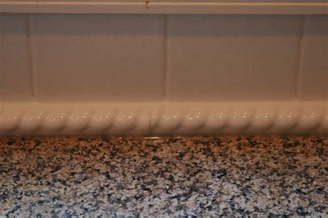 Decorative Trim To Hide Gap Between Granite And Tile Backsplash This