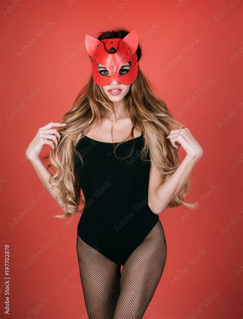 Sexy Caucasian Girl In Red Cat Mask Looks Very Sensually Isolated On Pink Background