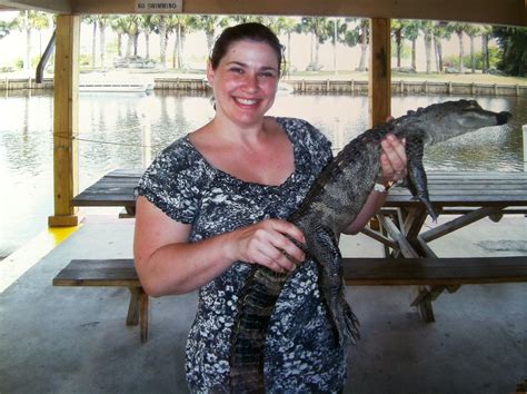 Woman Holding Baby Gator Too A Day In Motherhood