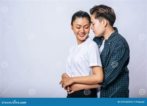 Two Female Lovers Standing And Hugging From Behind Stock Photo Image