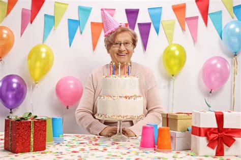 Happy Mature Woman Celebrating Birthday With A Cake Stock Image Image Of Mature Lounge 207154875