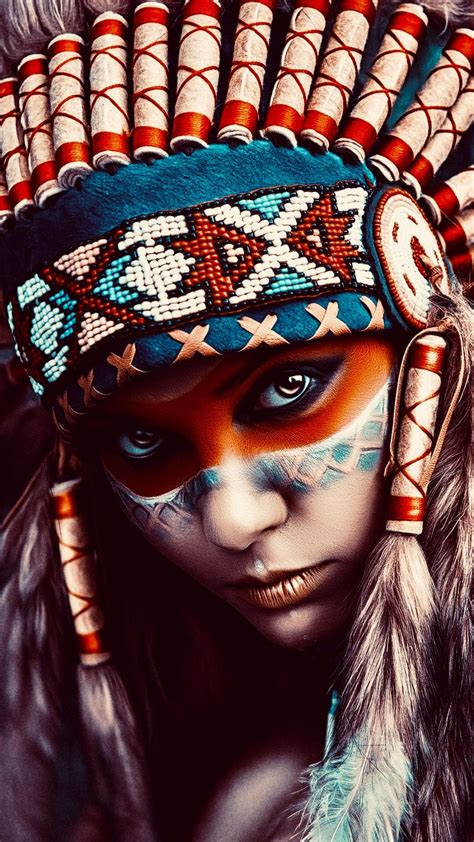 A Native American Woman With Painted Face And Headdress