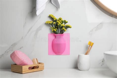 Silicone Vase With Flowers On White Marble Wall Over Countertop In