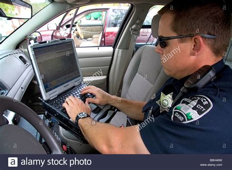 Top secret sci job description: Police officer using a mobile data terminal computer ...