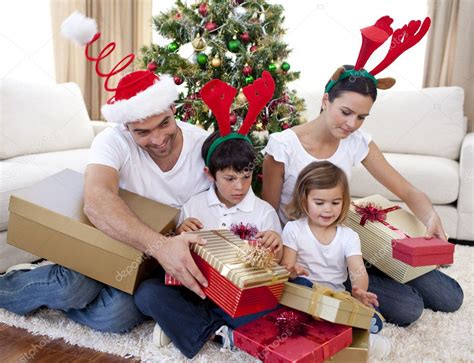 Happy family opening Christmas presents at home — Stock Photo