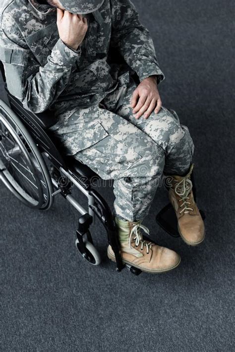 Disabled Military Man In Uniform Sitting In Wheelchair And Covering