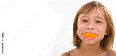 A Young Girl With An Orange Peel Smile Stock Photo And Royalty Free