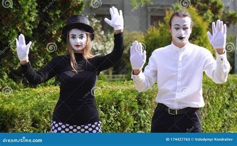 Two Young Funny Mimes Behind An Invisible Glass Box Or Wall Two Mimes